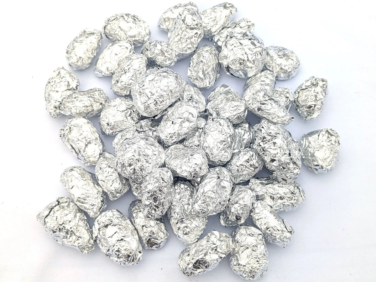 Group of individually foil-wrapped barn owl pellets