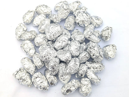 Group of individually foil-wrapped barn owl pellets